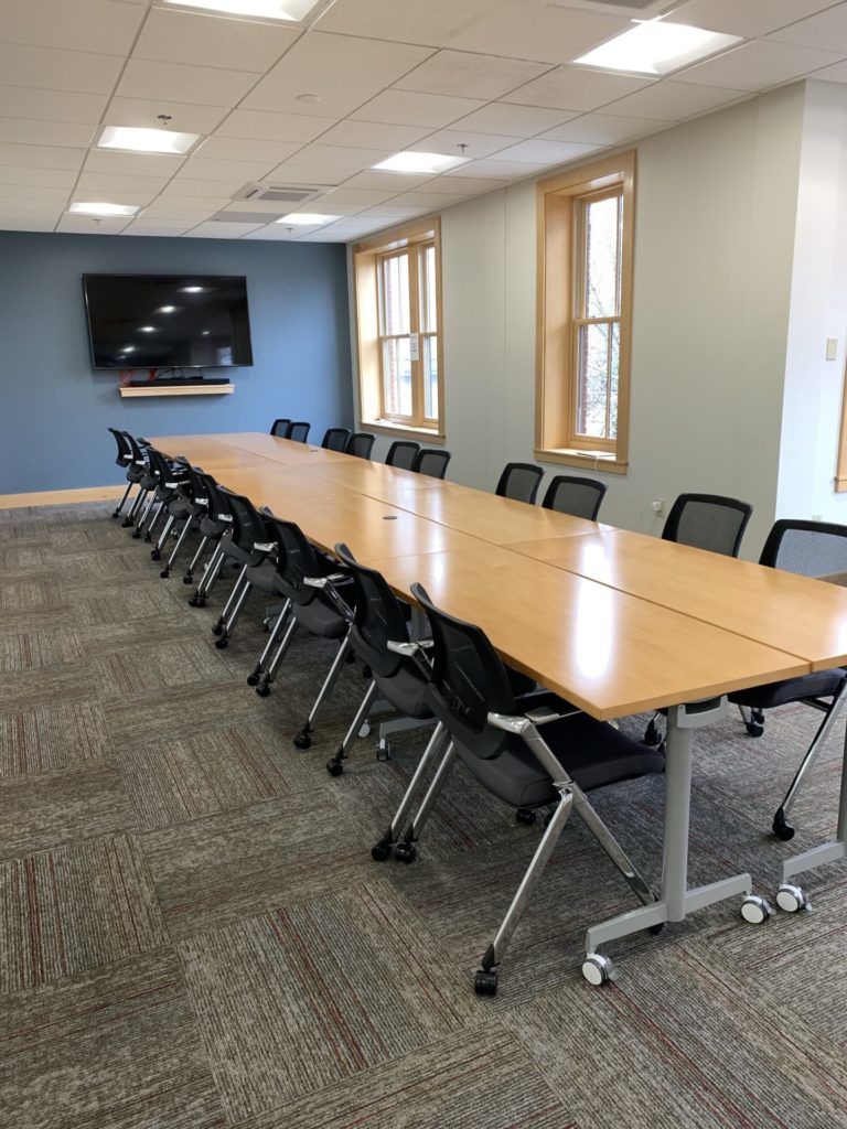 Upstairs Conference Room setup with 8 tables, conference style, and 20 chairs