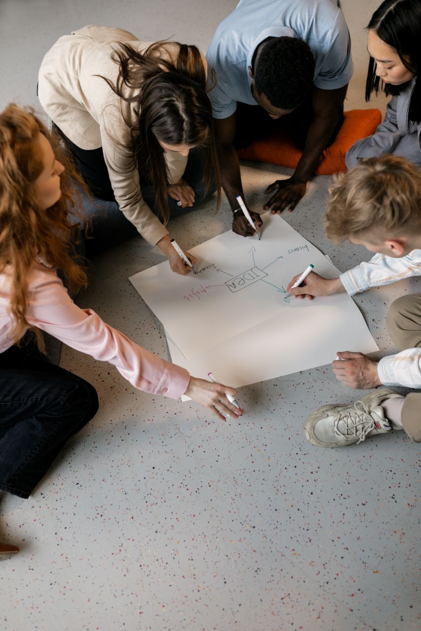 team of young people planning their business idea on paper
